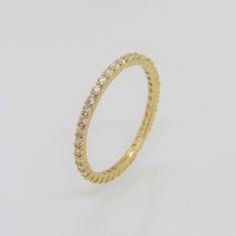 Vintage 14K Solid Yellow Gold White Topaz Eternity Band Ring....Marked 14K...Total of weights 1.1grams... Size 7...Measure of band 1.5MM...It's in very good condition. Classic Eternity Band With Halo For Gift, Classic Eternity Band With Halo As A Gift, Classic Eternity Band With Halo Detail As A Gift, Gold Cubic Zirconia Halo Eternity Band, Classic 14k Gold Eternity Band With Vs Clarity, Stackable Yellow Gold Round Eternity Band, Gold Eternity Band With Vs Clarity, Yellow Gold Stackable Round Eternity Band, Gold Eternity Band With Vs Clarity Round Cut