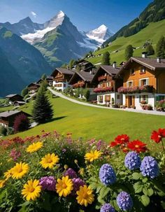 the flowers are blooming in front of the houses on the mountain side with mountains in the background