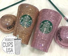 the starbucks cup has been made with sequins and is next to two other cups