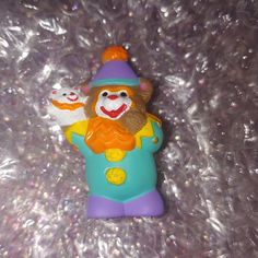 there is a plastic toy with a clown on it