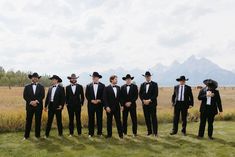 a group of men in tuxedos standing next to each other on a field