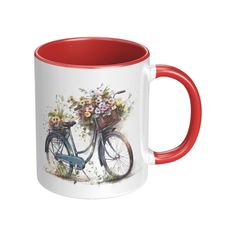 a red and white coffee mug with a painting of a bicycle holding flowers on it