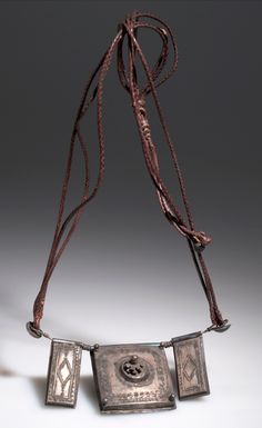 Africa | Amulet necklace from Liberia; possibly Malinke people | Hide and metal | ca. 1950 African Artifacts, Coco Chanel Fashion, American Museum Of Natural History, Dangle Belly Rings, Museum Of Natural History, The Division