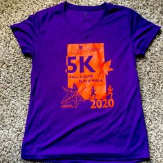 a purple v - neck shirt with the 5k fall color run logo on it