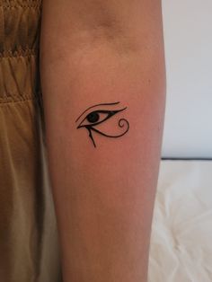 a woman's leg with an eye tattoo on it