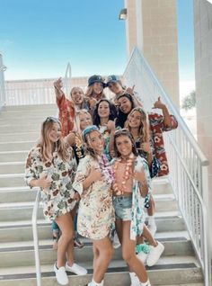 a group of young women standing on top of a set of stairs next to each other