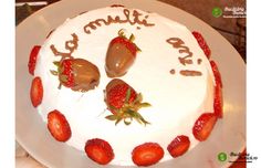 a birthday cake with strawberries and chocolate on it