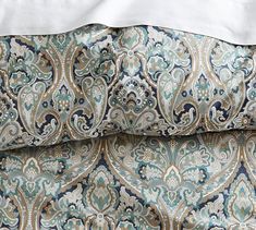 an image of a bed with blue and gold patterns on it