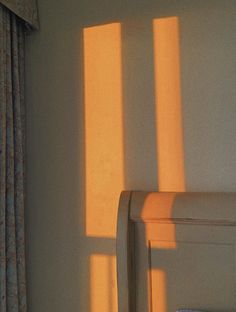 the sunlight is shining through two windows in a bedroom