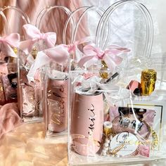 pink and gold gift bags filled with personalized items for someone's special occasion