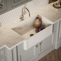 a white kitchen sink sitting under a faucet