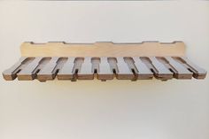 a wooden shelf that has several pieces of wood attached to the top and bottom of it