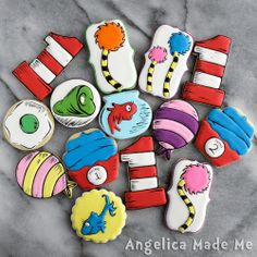 cookies decorated to look like dr seuss and the cat in the hat are arranged on a marble surface