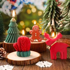 some christmas decorations are on a table with candles in the shape of animals and snowflakes