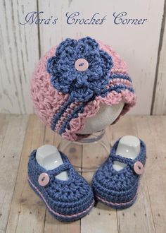 a crocheted hat, booties and slippers are sitting on a table