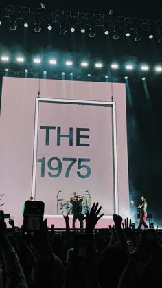 the band the 1970 is performing on stage with their hands up in front of an audience