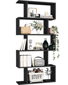 a black book shelf filled with lots of books and vases on top of it