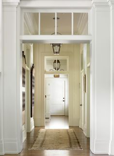 an open door leading into a white hallway