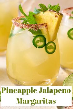 the pineapple jalapeno margarita is garnished with lime and sliced cucumber