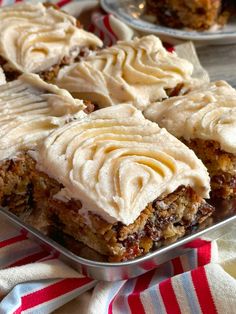 several pieces of cake sitting on top of a metal pan covered in frosted icing