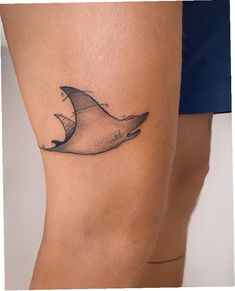 a manta ray tattoo on the thigh