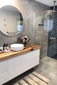 a bathroom with a sink, mirror and shower stall