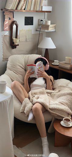 a woman sitting in a chair reading a book