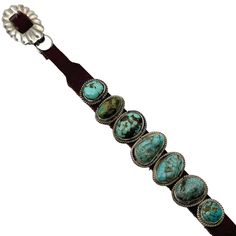 Embrace the captivating beauty of the Charles Rogers Navajo bracelet. Adorned with seven stunning turquoise stones, this piece makes a bold fashion statement. The 1/2" x 1" center stone and rich brown leather create a stunning contrast, secured with a dazzling sterling silver buckle. This bracelet can be easily adjusted to fit wrists up to 9" in circumference. The image reflects the exact product you will receive. Adjustable Southwestern Turquoise Concho Ring, Adjustable Western Turquoise Concho Ring, Adjustable Artisan Turquoise Ring With Concho, Turquoise Leather Concho Jewelry, Southwestern Turquoise Leather Jewelry, Turquoise Leather Jewelry, Horse Hair Bracelet, Hair Bracelet, Native American Bracelets