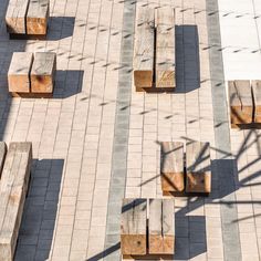 several wooden benches sitting on top of a brick walkway