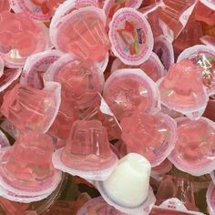 pink gummy bears are in plastic containers