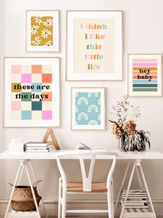 a white desk topped with lots of framed pictures