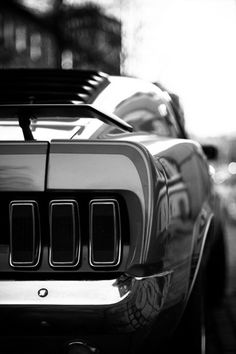 the front end of an orange sports car