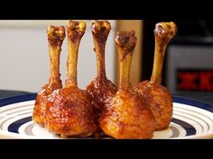 three pieces of meat with sauce on them sitting on a plate in front of a clock