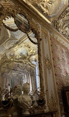 an ornately decorated room with statues and mirrors