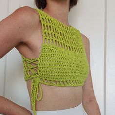 a woman wearing a green crochet crop top