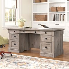 an office desk with two drawers and a chair