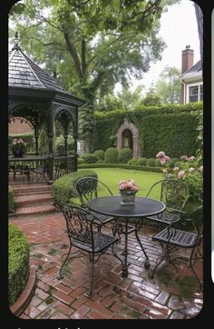 a gazebo in the middle of a garden with tables and chairs