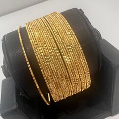 "* Handcrafted Gold Plated Bangle Set * High Quality 22 K Gold Plated 24 pc. Bangle set * Size: 2.2 has 2.2\" inner circle diameter ; 2.4 ( 2.31\" inner circle diameter) ; 2.6 ( 2.46\" inner circle diameter); 2.8 (2.64\" inner circle diameter) * Sold as a set of 24 bangles A gorgeous gold-plated bangle/ bracelet best exemplifies the careful craftsmanship done on it -- a specialty at Nemali Jewelry. It has a special tone of elegance attached to it. The intricate handmade design of the bangle / br 8 Bangles Gold Set, Handmade Gold Bangles, Luxury Gold Bangle For Diwali, Luxury Round Bangle For Wedding, Luxury 22k Gold Bangle, Elegant Gold Bangle For Navratri, Elegant Gold Bracelets For Navratri, Gold Bangle For Wedding And Navratri, Elegant Gold Bracelet For Navratri