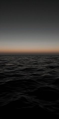 the ocean is very dark and calm at night