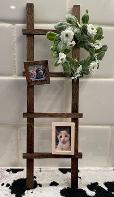 a wooden ladder with pictures and flowers on it