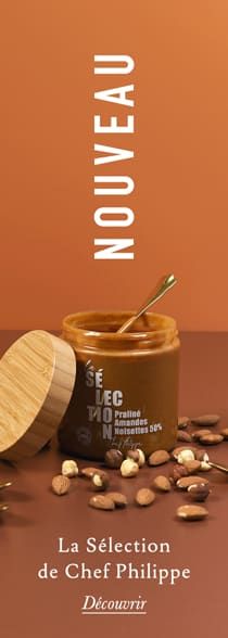 a jar of almonds next to a wooden spoon on a brown surface with the words'la selection de chef philippe decouri '