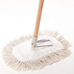 a white mop with a wooden handle on a white surface