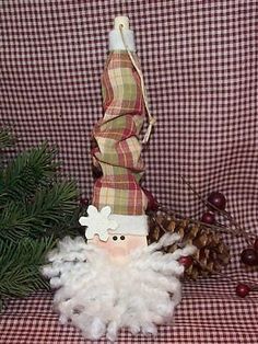 a christmas decoration with a santa clause and pine cones