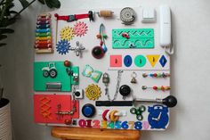 a refrigerator covered in lots of magnets and other assorted items next to a potted plant