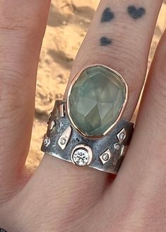 Large , beautiful Prehnite ring with lab diamonds, sterling Silver and 14k Gold Ring. Sterling Silver ring with Prehnite set in 14k gold bezel and gold elements on the band -oxidized -Band Width : 12mm -Thickness: 1,5mm -Lab created diamond 0.14ct -Lab created diamonds 0.03ct (5pcs) Fits a size 6 This statement Ring in Solid 925 Sterling Silver and 14k Gold is absolutely beautiful. Handcrafted Ring. Ring will be packed in a beautiful gift bag and box - ready for giving! PLEASE NOTE- We offer sta Prehnite Ring, Natural Opal Ring, Bohemian Ring, Bohemian Rings, Large Ring, Handcrafted Rings, 14k Gold Ring, Ring Ring, Lab Created Diamonds