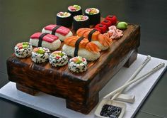 a wooden tray topped with lots of sushi