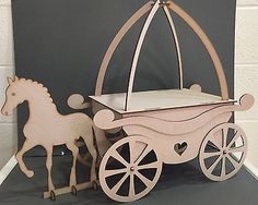 a baby carriage with a horse and buggy on the front is made out of plywood