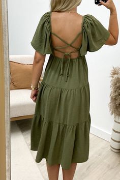 Flaunt your unique style in the "Enchanting You" Midi Dress. This playful olive green dress features flounce sleeves and a tiered design, complete with a back cross tie for added charm. Perfect for any occasion, this dress will have you feeling confident and enchanting. 100% Polyester Riley is a size 1, wearing a small. Olive Green Dress, Sky Collection, Olive Green Dresses, Feeling Confident, Flounce Sleeve, Mini Shirt Dress, Long Tops, Short Tops, Green Dress