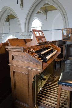 an old pipe organ in a church with stained glass windows