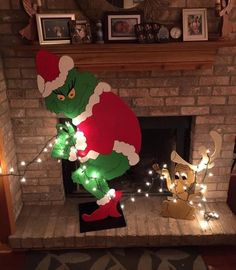 an inflatable dr seuss christmas decoration with lights on the fireplace mantel